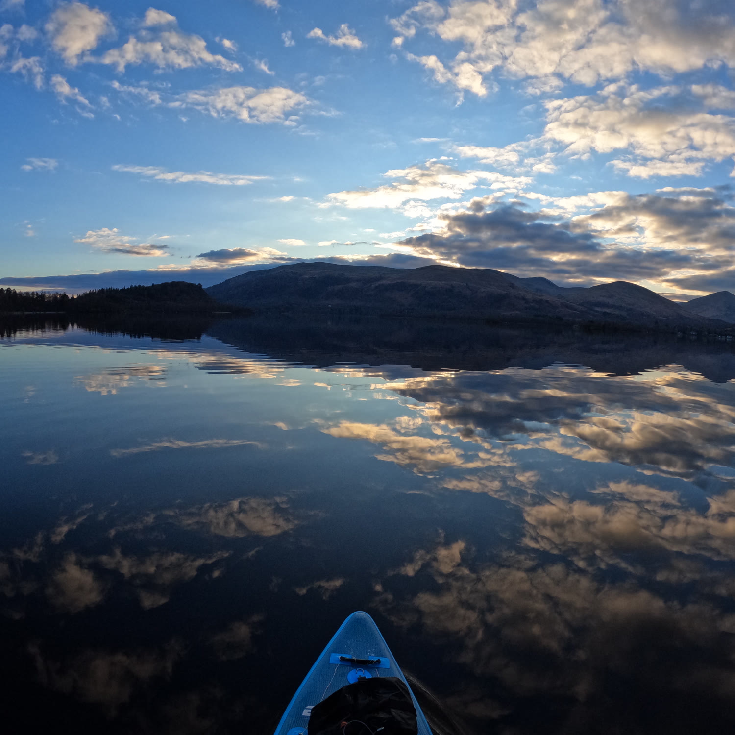 Loch Lomond cushion design: clouds mirrored on still water, seen from a paddleboard